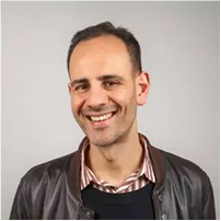 A headshot photograph of Greg Shields smiling. 